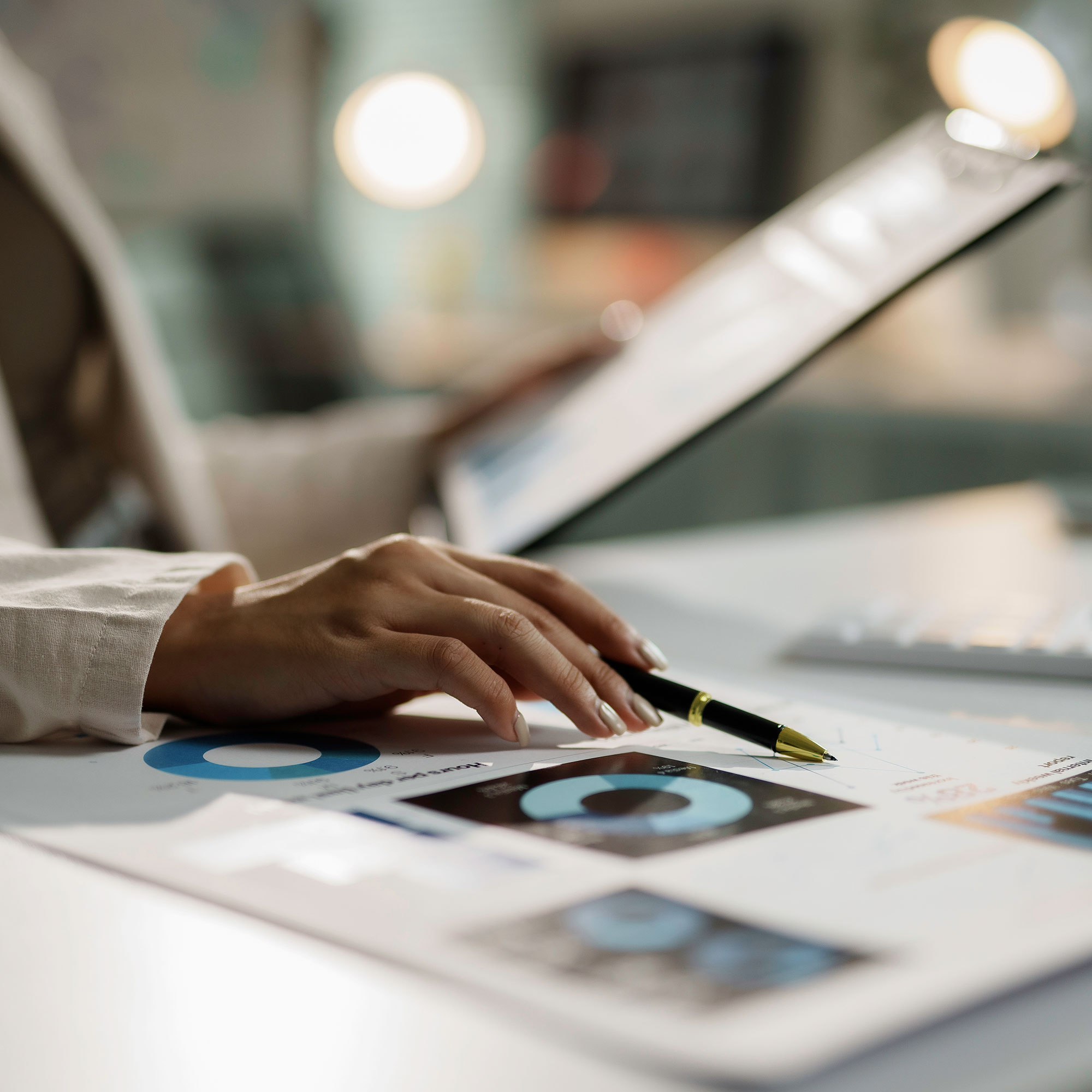 employee using pen to point out stop-loss models and reports made using predictive analytics